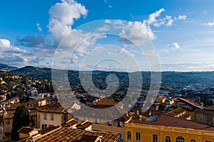 The panoramic cityscape view of a CÃ´te d`Azur town center and the Alps mountains