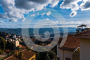 The panoramic cityscape view of a CÃ´te d`Azur town center and the Alps mountains