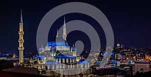 Panoramic cityscape with Yeni Cami or New Mosque after sunset in Istanbul Turkey