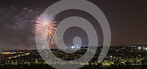 Panoramic of colorful fireworks in the distance.