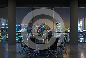 Panoramic conference room in modern office, cityscape of Singapore skyscrapers at night. Black chairs and a black round table.