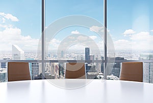 Panoramic conference room in modern office, New York city view from the windows. Close-up of the brown chairs and a white round ta