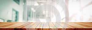 Panoramic empty clean wood counter table top on blur glass window white light background for product morning scene display montage