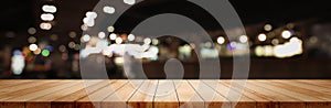 Panoramic empty clean wood counter table top on blur street night cafe background use for pub coffee shop montage dark scene,