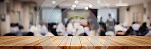 Panoramic empty clean wood counter table top on blur student study in classroom white light background for product education