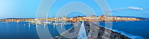 Panoramic evening cityscape of  Alghero port and historical part of cit
