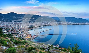 Panoramic evening view of the bay of the Mediterranean Sea and cityscape with the old historic tower, Alanya, Turkey