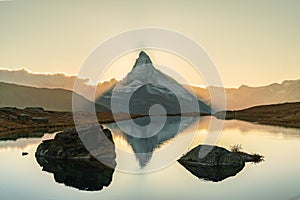 Panoramic evening view of Lake Stellisee with the Matterhorn Cervino Peak in the background. Impressive autumn scene of