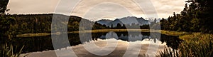 Panoramic famous twilight reflected view of beautifully romantic Aoraki/Mt Cook and Mount Tasman on water of Lake Matheson