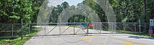 Panoramic gate closed at the entrance to park and nature preserve in suburban Houston, Texas, USA