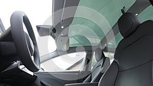 Panoramic glass sun roof in the modern electric car. Clean sunroof and view at the sky from the inside or car interior