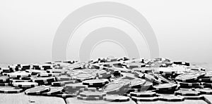 Panoramic grayscale closeup of a pile of poker chips on the table