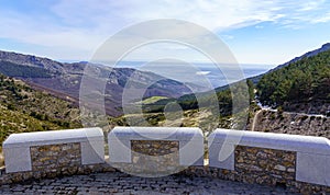 Panoramic green landscape with green plants, rocks and blue sky with sun flare. La Morcuera, Madrid photo