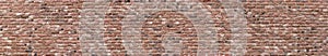 Panoramic high resolution vintage pink, black and red brick wall background texture. Architecture grunge detail abstract theme.