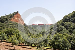 Panoramic image of the Leonese mountains of Las Medulas rich in clay and red limestone soil well covered