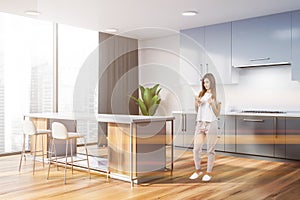 Panoramic kitchen corner with bar, woman