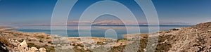 Panoramic landscape of Dead Sea and Jordan mountains in middle day. Israelian border coastline