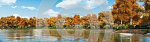 Panoramic landscape of forest lake shore at autumn