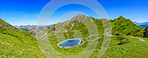 Panoramic landscape of mountains of Alps in summer with flowers and a lake in Portes du Soleil, France