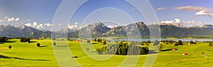 Panoramic landscape in region Allgaeu with lake and alps mountains