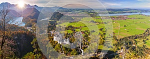 Panoramic landscape in region Allgaeu with mountain range, lake and maedow