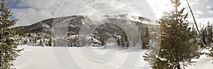 Snow covered landscape of Roaring Mountain geyser vents in Yellowstone National Park in winter