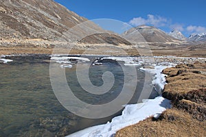Panoramic landscape view of partially frozen Lachung river at Zero Point or Yumesamdong in winter. It is a famous tourist place in