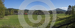 Panoramic landscape with view on village Marenice in Lusitian mountains with traditional wooden cottage and lush green