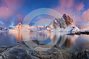 Panoramic landscape, winter mountains and fjord reflection in water. Norway, the Lofoten Islands.