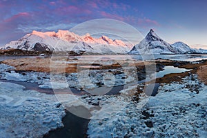 Panoramic landscape, winter mountains and fjord reflection in water. Norway, the Lofoten Islands.