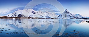 Panoramic landscape, winter mountains and fjord reflection in water. Norway, the Lofoten Islands.