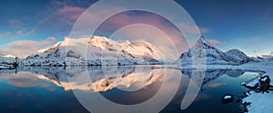 Panoramic landscape, winter mountains and fjord reflection in water. Norway, the Lofoten Islands. photo