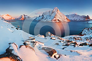 Panoramic landscape, winter mountains and fjord reflection in water. Norway, the Lofoten Islands.