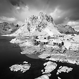 Panoramic landscape, winter mountains and fjord reflection in water. Norway, the Lofoten Islands. Colorful winter sunset.