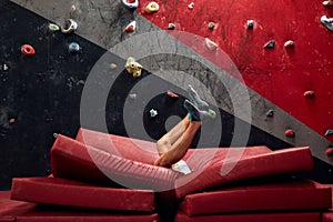 Panoramic man bouldering at an indoor climbing centre.