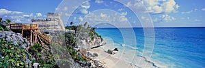 A Panoramic of Mayan ruins of Ruinas de Tulum (Tulum Ruins) and El Castillo at sunset, with beach and Caribbean Sea, in Quintana