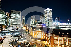 Panoramic modern city skyline bird eye aerial night view with tokyo station under dramatic glow and beautiful dark blue sky in To