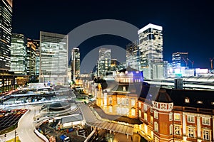 Panoramic modern city skyline bird eye aerial night view with tokyo station under dramatic glow and beautiful dark blue sky in To