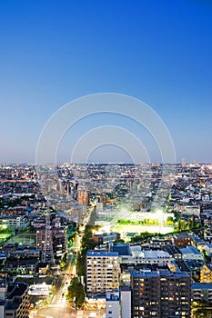 Panoramic modern city skyline bird eye aerial night view under dramatic neon glow and beautiful dark blue sky in Tokyo, Japan