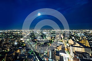 Panoramic modern city skyline bird eye aerial night view under dramatic neon glow and beautiful dark blue sky in Tokyo, Japan