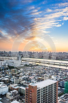 Panoramic modern city skyline bird eye aerial view with Mountain Fuji under dramatic sunset glow and beautiful cloudy sky in Tokyo