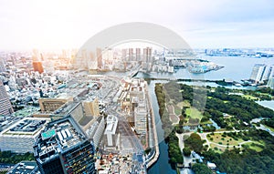 Panoramic modern city skyline bird eye aerial view of Odaiba bay and bridge under dramatic sunrise and morning blue cloudy sky in