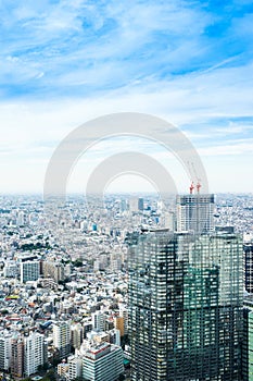 Panoramic modern city skyline bird eye aerial view under dramatic sun and morning blue cloudy sky in Tokyo, Japan