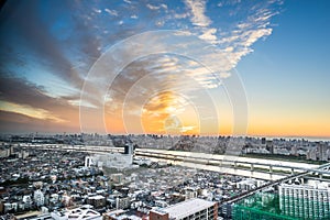 Panoramic modern city skyline bird eye aerial view under dramatic sunset glow in Tokyo, Japan