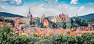 Panoramic morning cityscape of Sighisoara. Sunne summer view of medieval town of Transylvania, Romania, Europe. Traveling concept