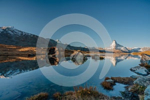 Panoramic morning view of Lake Stellisee with the Matterhorn Cervino Peak in the background. Impressive autumn scene of