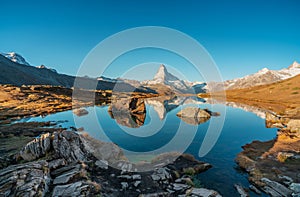 Panoramic morning view of Lake Stellisee with the Matterhorn Cervino Peak in the background. Impressive autumn scene of