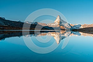 Panoramic morning view of Lake Stellisee with the Matterhorn Cervino Peak in the background. Impressive autumn scene of