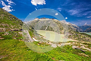 Panoramic mountain road leading to Grimselpass with Grimselsee in Swiss Alps