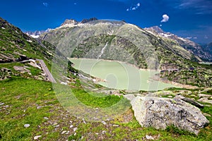 Panoramic mountain road leading to Grimselpass with Grimselsee in Swiss Alps